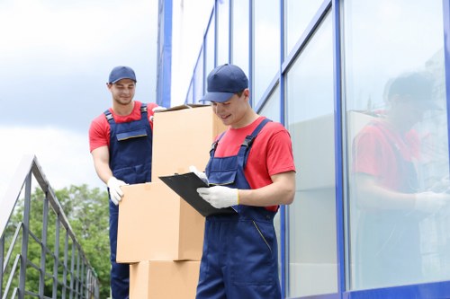 Removal team planning a Canary Wharf apartment move with boxes and furniture