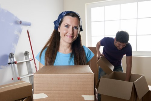 Local moving team handling packing materials in an East London property